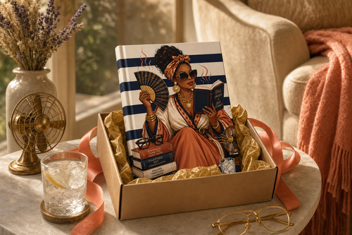 Hot Flashes and Plot Twists Menopause Book Club hardcover journal in kraft gift box with coral ribbon dried lavender and brass vintage fan beside cozy reading chair