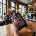 E-reader with "morbidly morbid" design and red lips visible at eye level.