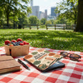 Picnic blanket with berries, journal, sunglasses, and item featuring text "Rest is Productive".