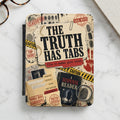 "The Truth Has Tabs" book cover with detective-themed graphics, fingerprints, and file folders.