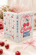 Notebook with cherry design and text on a soft background