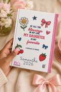 Hand holding personalized white coquette daughter keepsake journal with decorative elements