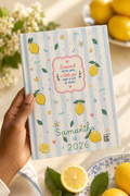 Hand holding personalized Nonna lemon keepsake journal surrounded by lemons and florals