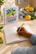 Open personalized Nonna lemon keepsake journal with hand writing next to fresh lemons