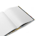Open notebook with floral edge on a white background