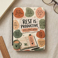 Journal with "Rest Is Productive" and affirmations on a textured background.