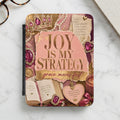 "Joy Is My Strategy, Grace Moves First" journal with crown, heart, and inspirational text.