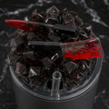 Close detail of smoky black resin ice tumbler lid with red-splattered miniature knife and cleaver charms