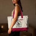 Cream tote bag with maroon trim and graphic reading "I'm Not a Bookworm I'm a Book Dragon."