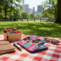 E-reader with a "My Story Has Range" collage case, berries, notebook, and sunglasses.