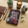 "Morally Gray Pages read after midnight" sticker on a black background with red accents.