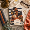 Hot Flashes and Plot Twists Menopause Book Club hardcover journal styled flat lay with brass fan tortoiseshell reading glasses coral scarf and eucalyptus on cream linen